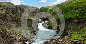 Long exposure of a waterfall in a rocky landscape in Iceland