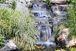 Long exposure waterfall in a stream in a garden