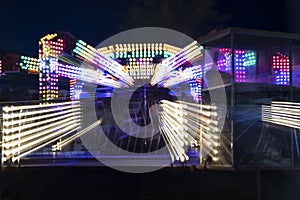 Long exposure zoom of carnival ride lights abstract background