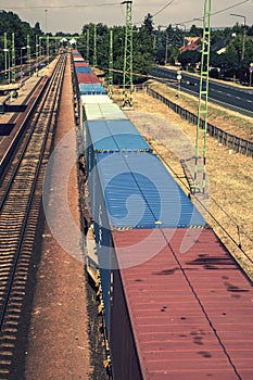 Long freight train with containers at railway station