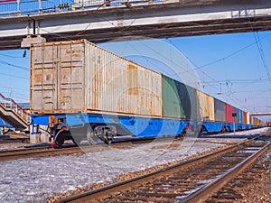 Long freight train of Idler flatcars loaded with intermodal 40-fts containers on the marshalling yard of Trans-Siberian Railway