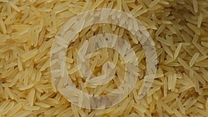 Long grain parboiled basmati rice pouring macro slow motion