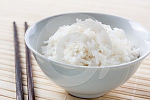 Long grain rice bowl with chopsticks