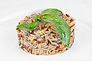 Long grain white and brown rice cooked with green leafs