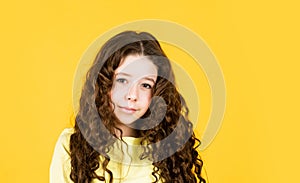 Long hair. Easy hairdo. Beauty supplies. Perfectly untangle curly hair. Pretty girl curly hair yellow background