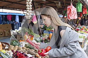 Long hair girl on market with vegetables