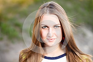 Long hair girl`s portrait outdoor.