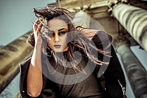 Long hair girl with scary makeup on the old church background