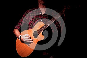 Long hair guy playing guitar acoustic