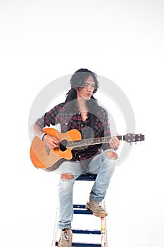 Long hair guy playing guitar acoustic