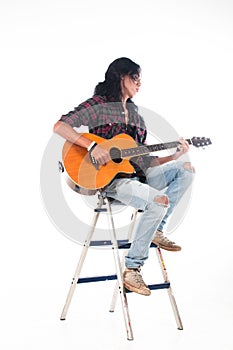 Long hair guy playing guitar acoustic