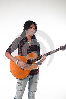 Long hair guy playing guitar acoustic