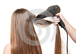 Long hair, and hair dryer in hand isolated on white.