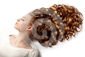 Long hair. Waves Curls updo hairstyle in salon. Fashion model, w