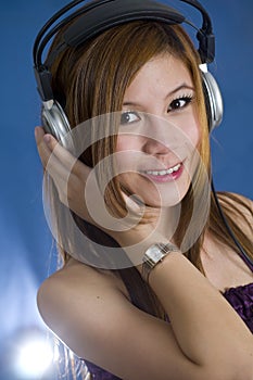 Long haired Asian girl listening to music