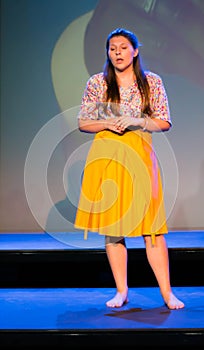 long-haired brunette woman in various positions and barefoot expressions with long skirt