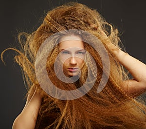 Long-haired curly redhead woman