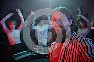 Long haired DJ taking selfie photo at retro disco party