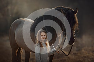 Long haired Little girl  in casual style with brown horse