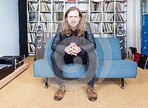 Long haired man intensively listening to music photo