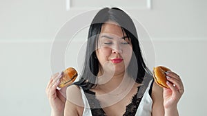 Long-haired woman feels temptation for juicy hamburgers