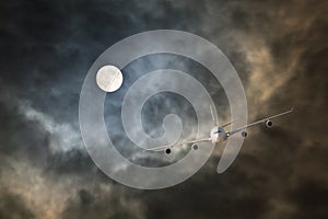 Long-haul night flight through clouds in light of full moon