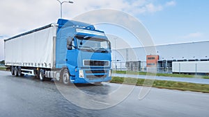 Long Haul Semi-Truck with Cargo Trailer Full of Goods Travels on the Highway Road. Daytime Driving