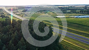 Long Haul Semi Truck And Vehicle Driving On Asphalt Highway In Rural Aerial View