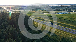 Long Haul Semi Truck And Vehicle Driving On Asphalt Highway In Rural Aerial View