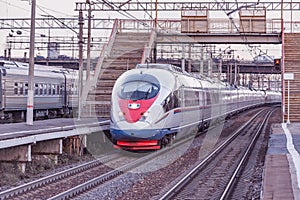 Long highspeed train moves to Saint Petersburg at sunset time