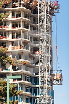 Long hoisting tower crane in construction new apartment building process. White Rock  British Columbia