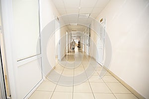 Long hospital corridor with a silhouette of a doctor