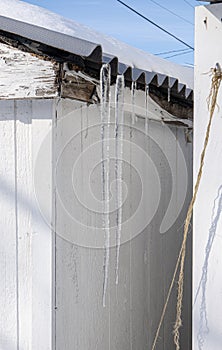 Long icicles are hanging from your shed after a big snow storm