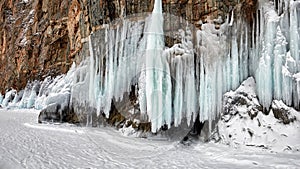 Long icicles on rock. Lake Baikal