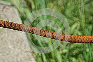 Long iron piece of rebar in red rust
