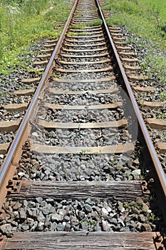 long iron train rail tracks to infinity with no people