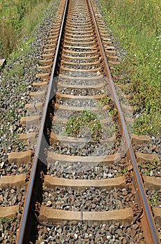long iron train rail tracks to infinity with no people