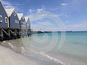 Long jetty with beach houses and shallow water