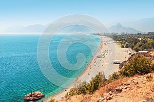 long Konyaalti beach in Antalya. Turkish resort and Riviera with the Taurus mountains in the background