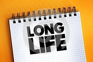 Long Life text quote on notepad, concept background
