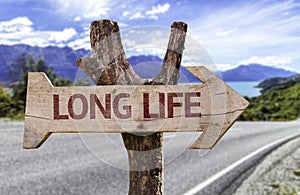 Long Life wooden sign with a street background photo