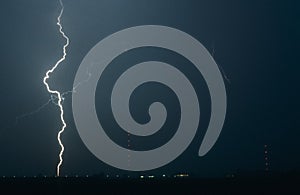 Long lightning bolt strikes the earth during a severe thunderstorm