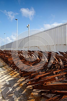 A long line of discarded and rusty anchors