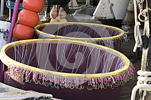 Long line fishing containers with hooks inside a boat