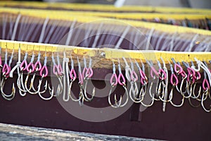 Long line fishing containers with hooks inside a boat