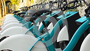 Long line of parked bikes in the automatic bike rental station