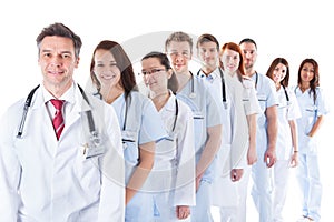 Long line of smiling doctors and nurses