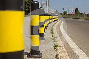 Long line of yellow and black traffic signs to deter the cars around the road