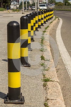 Long line of yellow and black traffic signs to deter the cars around the road