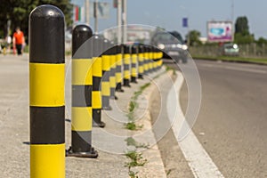 Long line of yellow and black traffic signs to deter the cars around the road